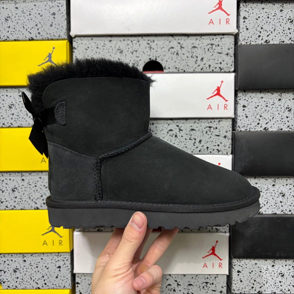 UGG Mini Bailey Bow Ankle Boot – Suede Boot with Tonal Black Shearling Lining, Black Satin Bow & All-Black Lug Sole in Black