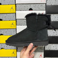 UGG Mini Bailey Bow Ankle Boot – Suede Boot with Tonal Black Shearling Lining, Black Satin Bow & All-Black Lug Sole in Black